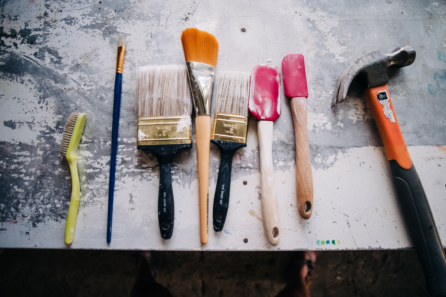 Artist's tools: Brushes, spatulas and a hammer